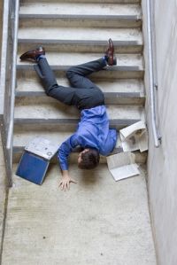 Person on the floor in front of the stairs
